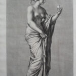A full length staute of a female holding an apple